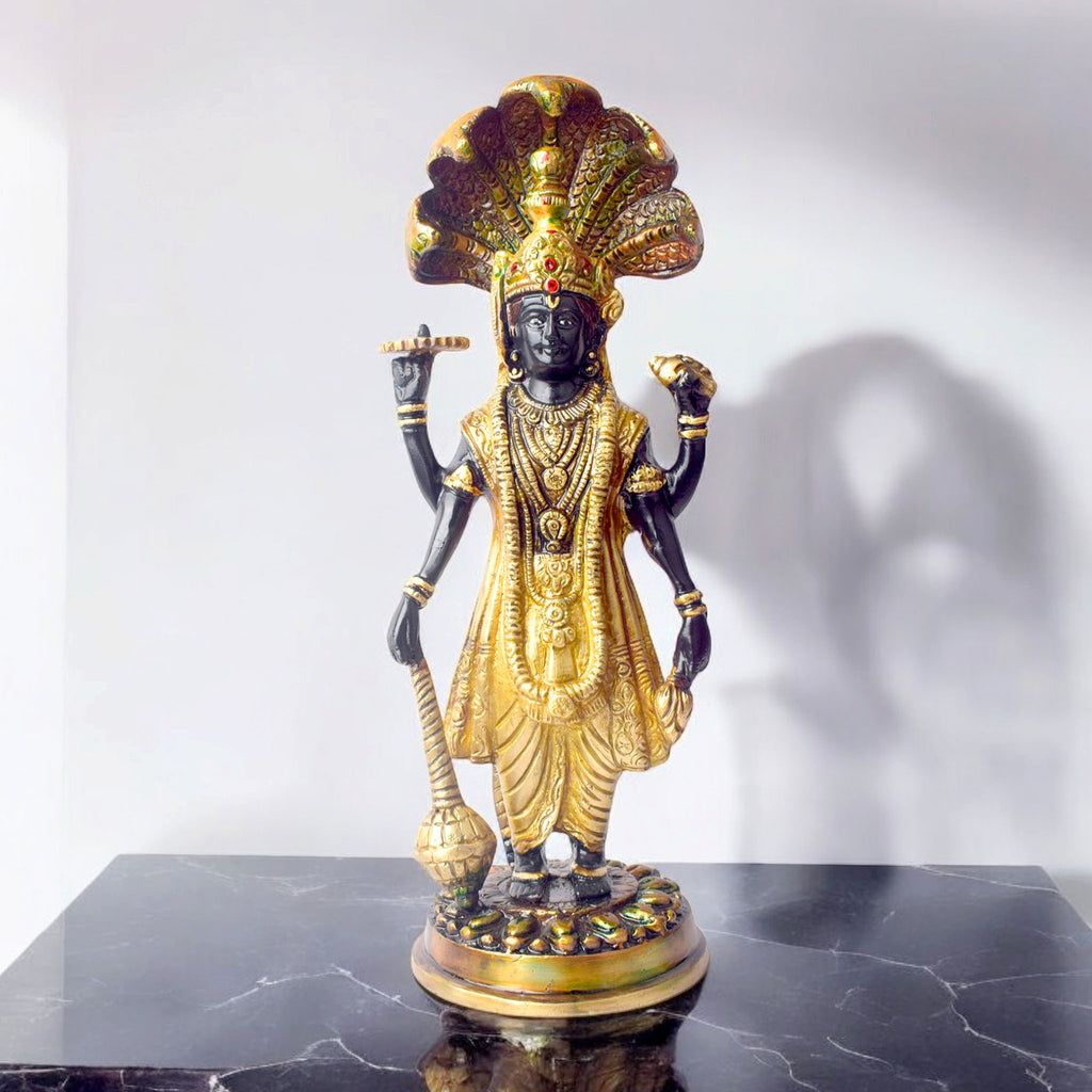  This elegant brass statue of Lord Vishnu seated on the mighty Seshnag is a powerful symbol of divine protection, balance, and cosmic order. The intricate craftsmanship beautifully depicts Lord Vishnu in his serene and majestic form, with the multi-headed Seshnag providing a protective canopy. 