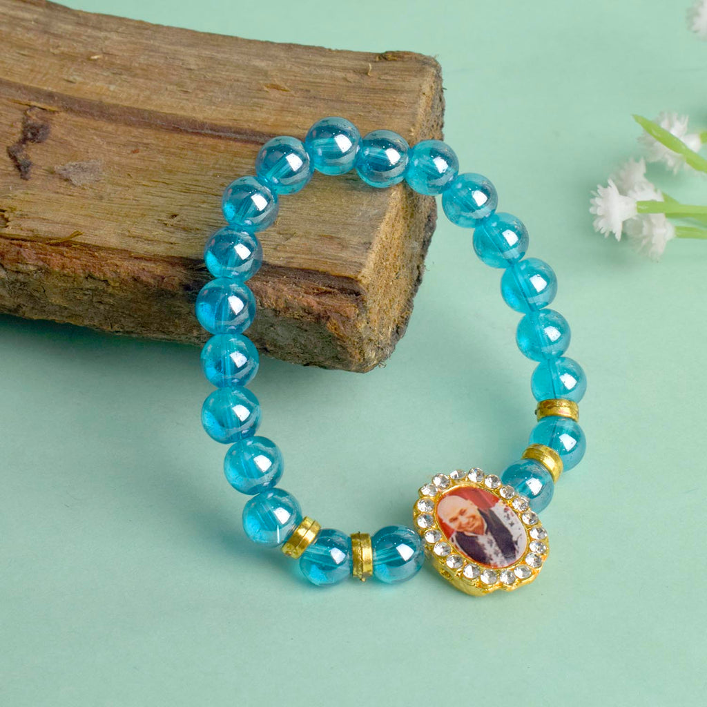 Blue Shiny Beads Single Layer Guruji Swaroop Bracelet featuring sparkling blue beads and Jai Guruji Swaroop – perfect for minimalist spiritual wear, meditation, and gifting. India’s Largest Pooja Accessories Brand – www.satvikstore.in