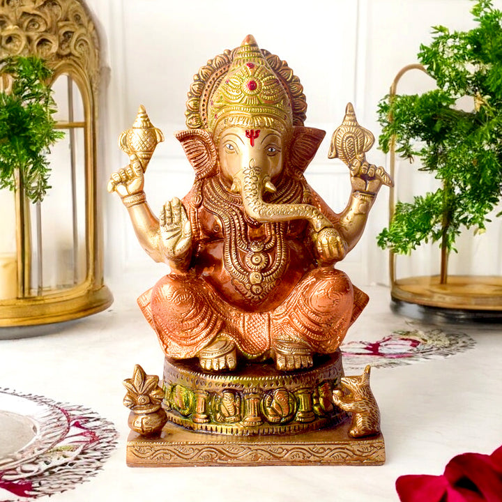 8.7 Inch Brass Idol of Colored Brass Ganesh Statue. Enhance your home with the vibrant charm of this Colored Brass Ganesh Statue, a perfect fusion of tradition and artistry. Crafted from high-quality brass and adorned with vivid hand-painted colors, this exquisite idol beautifully represents Lord Ganesha, the remover of obstacles and symbol of prosperity.  India's Largest Puja Accessories Brand - Satvik