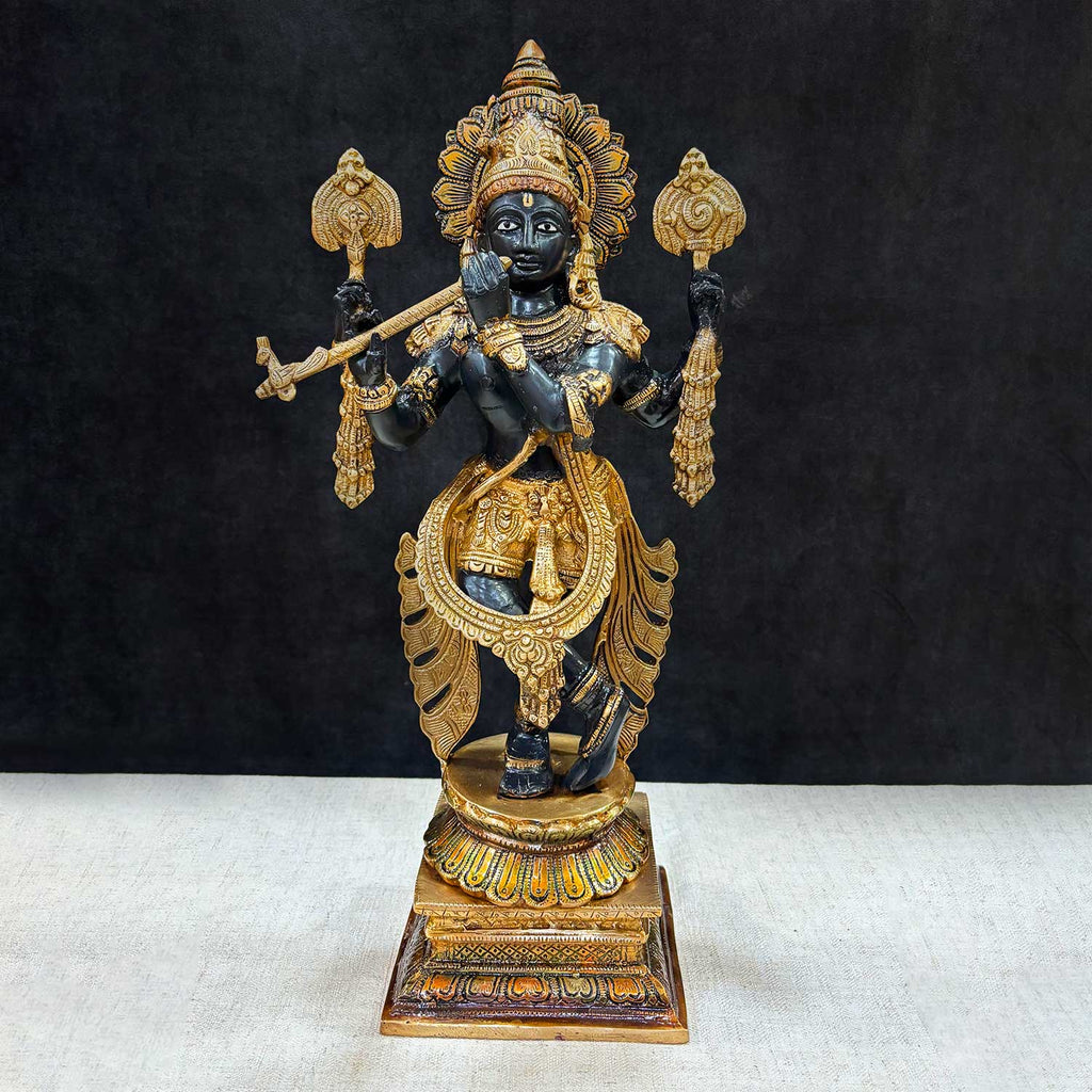 Brass Idol of 19 Inch Brass Chola Krishna Sculpture Playing the Flute. Bring home the divine charm of Lord Krishna with this exquisite 19-inch Brass Chola Krishna Sculpture. Expertly crafted, this statue captures Lord Krishna in his iconic pose, gracefully playing the flute. India's Largest Puja Accessories Brand - Satvik