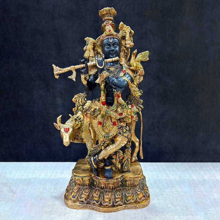 Brass Idol of 17 Inch Brass Krishna Statue with Cow. Enhance your space with the divine presence of this 17-inch Brass Krishna Statue with Cow. This beautifully crafted sculpture features Lord Krishna in a serene pose, accompanied by a cow, symbolizing the deep connection between the divine and nature. India's Largest Puja Accessories Brand - Satvik