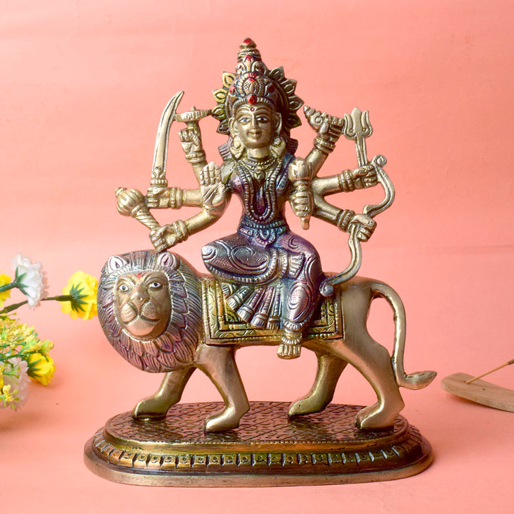  Embrace the powerful energy of Maa Durga with this 8.5-inch Brass 8-Armed Durga Idol, beautifully depicted riding her mighty lion. This meticulously crafted statue showcases Maa Durga in her most majestic form, symbolizing strength, courage, and divine protection. 