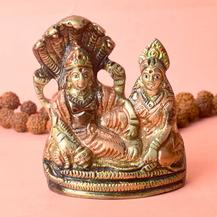  The 4.7 Inch Vishnu Ji Resting on Snake - Small Divine Figure is a beautifully crafted miniature statue that showcases Lord Vishnu in a serene and tranquil pose. Resting gracefully on the multi-headed serpent, Sheshnag, this divine figure symbolizes the eternal peace and protection Vishnu provides to the universe. 