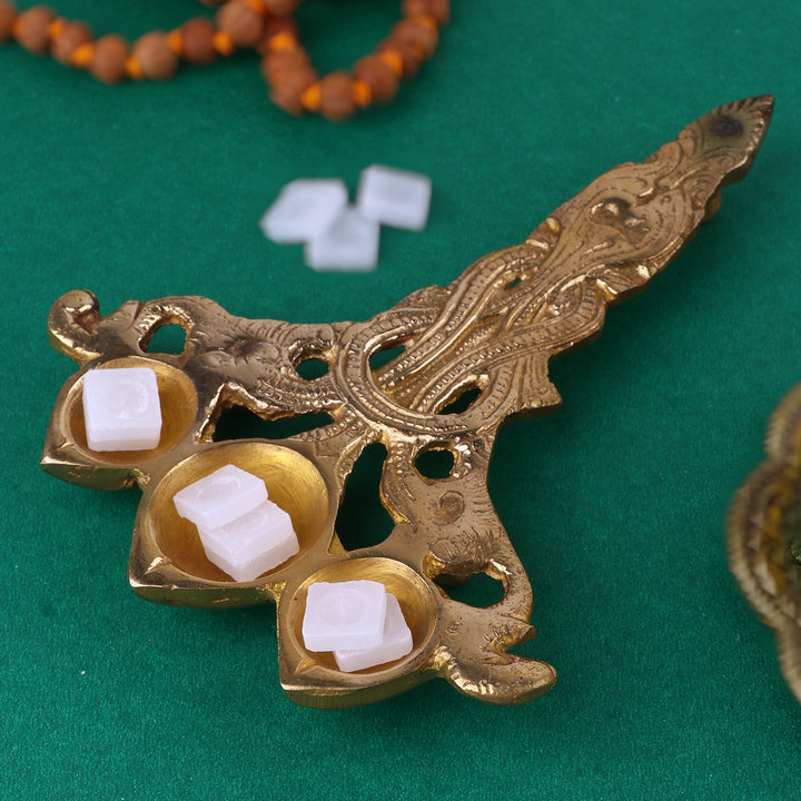Designer Brass Trimukh Kapoor Aarti Spoon Medium, a medium-sized brass spoon with a unique Trimukh design, perfect for performing aarti with Kapoor (camphor) during pooja and spiritual rituals. 
India’s Largest Pooja Accessories Brand – www.satvikstore.in 
