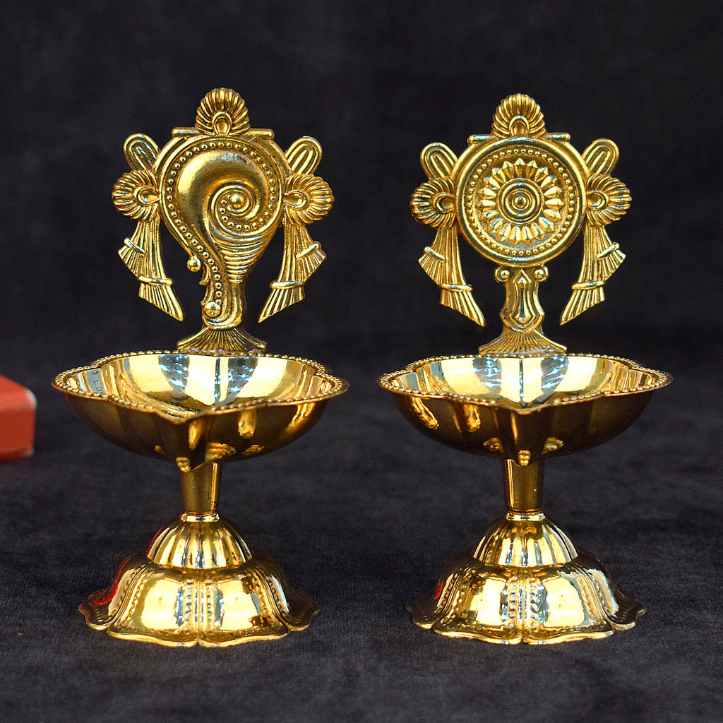 1 Pair of Prepossessing Designer Brass Shankh Chakra Diya – Exquisite brass diyas featuring Shankh and Chakra motifs, perfect for spiritual rituals and home décor. India’s Largest Pooja Accessories Brand – www.satvikstore.in