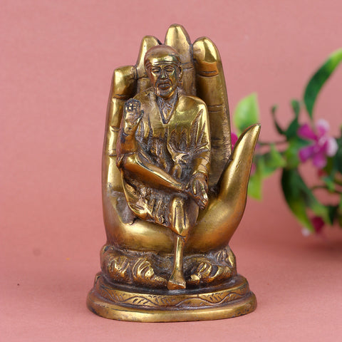 6.4 Inch Pure Brass Shirdi Sai on Hand Statue – Exquisitely Handcrafted Idol Depicting Shirdi Sai Baba Resting on a Divine Hand, Symbolizing Protection, Blessings, and Faith for Home and Temple Decor. No.1 Brass Idol Store www.satvikstore.in 