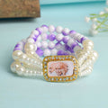 White & Lilac with White Pearl Four Layer Guruji Swaroop Bracelet featuring soft lilac beads, elegant white beads, and luminous white pearls with Jai Guruji Swaroop – perfect for spiritual wear, festive gifting, and daily devotion. India’s Largest Pooja Accessories Brand – www.satvikstore.in