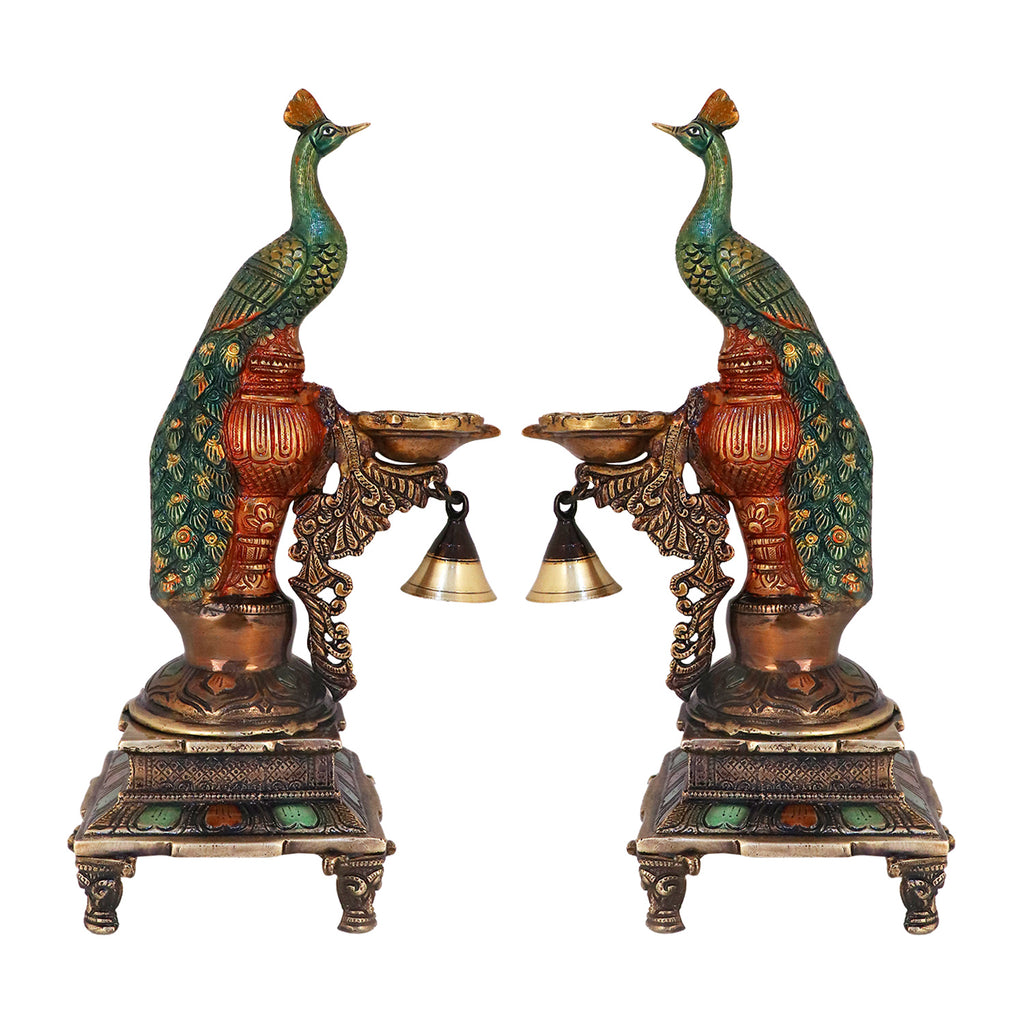 Satvik Stores Presents Brass Peacock Diya Stand.&nbsp;Any festive occasion will be made wonderfully auspicious by the grace and beauty of the Peacock Brass Handcrafted Hanging Diya. Given that it was made by hand, the piece's abnormalities and flaws only serve to enhance Diya's allure and charisma.