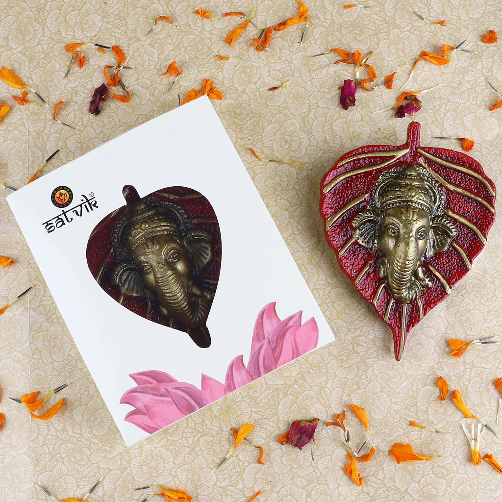 1 Pc Lord Ganesh Face on Leaf Patta Wall Hanging – A beautifully crafted decorative piece featuring Ganesh ji's face on a leaf-shaped patta for spiritual home decor. India’s Largest Pooja Accessories Brand – www.satvikstore.in